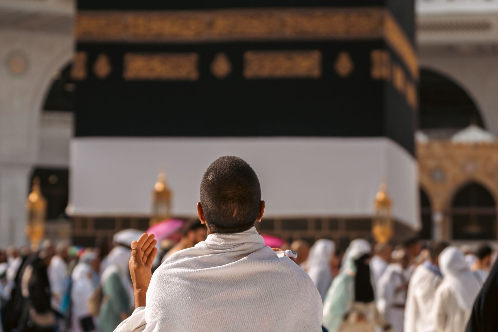 front of kaba with human pray